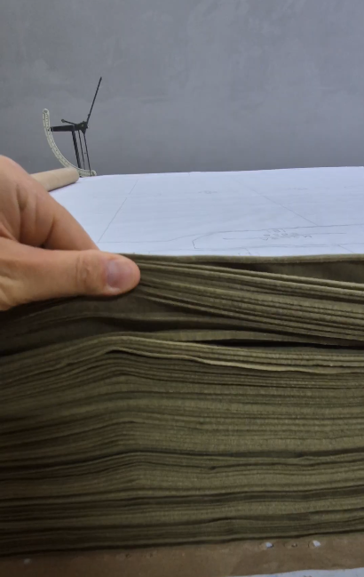Cut fabric panels lifted from the cutting table