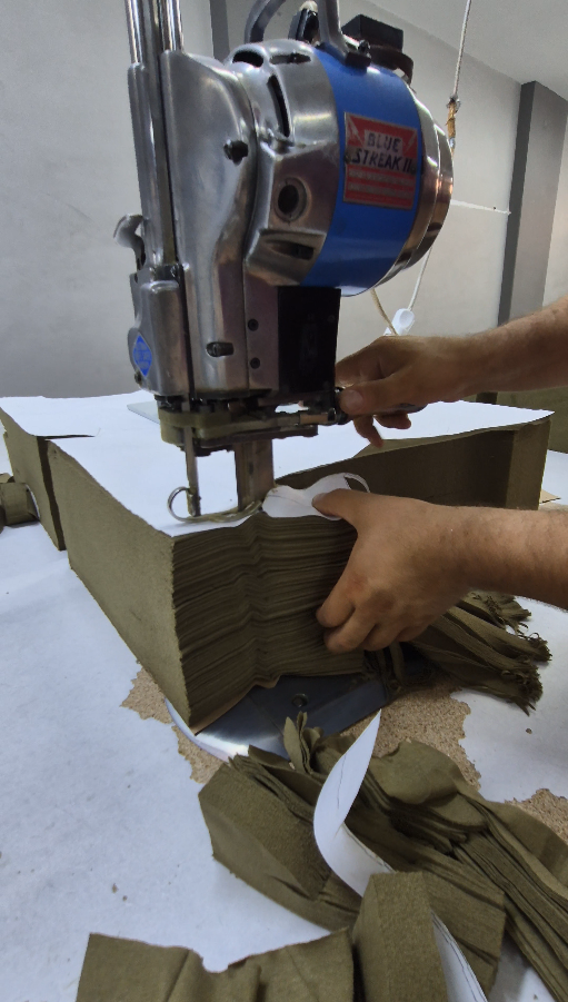 Close-up of fabric being cut to pattern, layer by layer