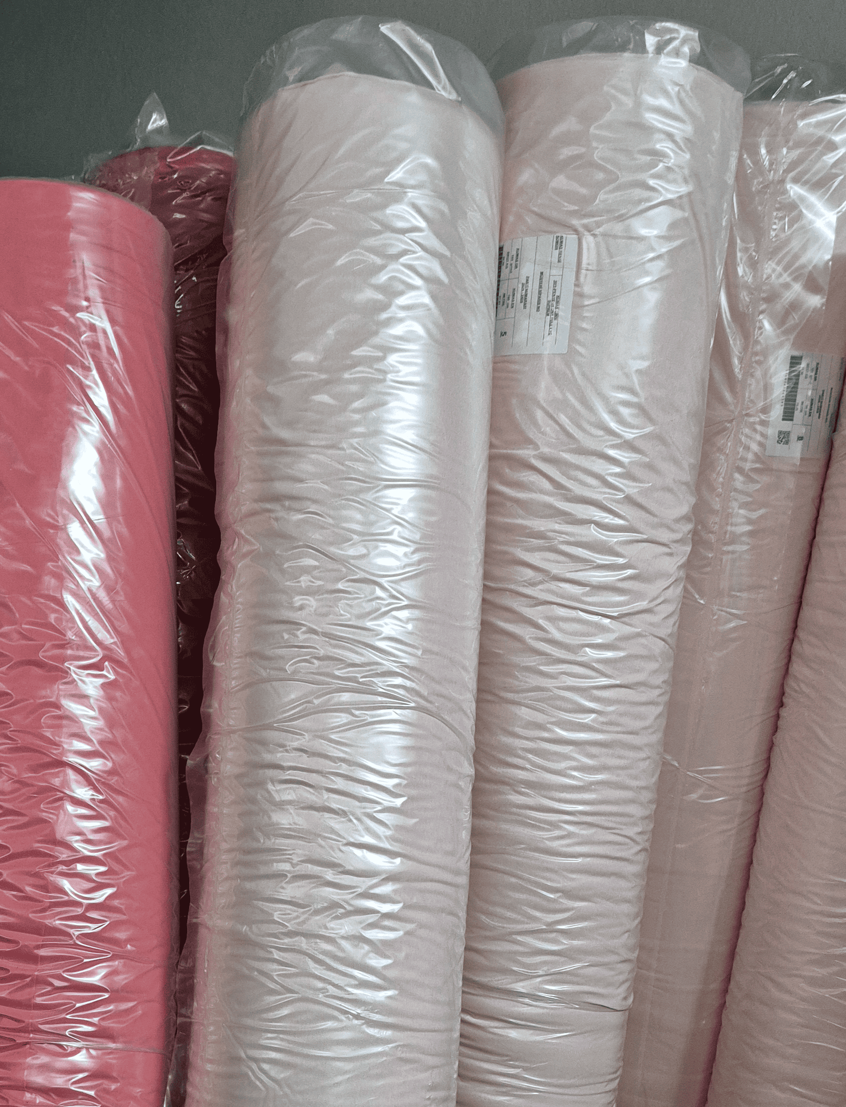 Roll of cotton fabric wrapped for storage at RedWhite Global's facility